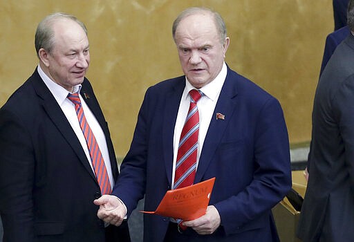 Russian Communist Party leader Gennady Zyuganov, right, gestures while speaking to lawmaker Valery Rashkin during a session prior to vote on a third reading of constitutional amendments at the State Duma, the Lower House of the Russian Parliament in Moscow, Russia, Wednesday, March 11, 2020. The Russian parliament has approved a sweeping constitutional reform that will allow President Vladimir Putin to stay in power for another 12 years after his current term ends in 2024. Wednesday's vote was the third and final reading. (AP Photo/Pavel Golovkin)