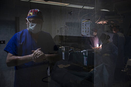 Dr. William Novick, of the Novick Cardiac Alliance medical team washes his hands before entering the operating room at the Tajoura National Heart Center in Tripoli, Libya, on Feb. 27, 2020. As a young medical resident at the University of Alabama, Novick, now 66, witnessed the suffering of children with congenital heart disease and the staggering disparities in health services between the U.S. (AP Photo/Felipe Dana)