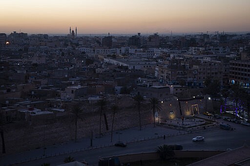 In this Feb. 29, 2020 photo, the walls surrounding the Old City are illuminated before sunrise in Tripoli, Libya. The country has been plunged into chaos since 2011, when a civil war toppled longtime dictator Moammar Gadhafi, who was later killed. (AP Photo/Felipe Dana)