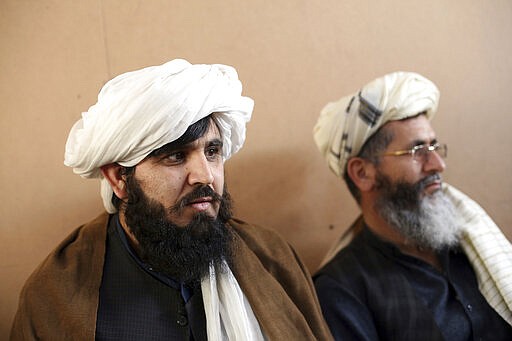 FILE- In this Dec. 14, 2019, file photo, jailed Taliban are seen after an interview with The Associated Press inside the Pul-e-Charkhi jail in Kabul, Afghanistan. After a series of delays, Afghan President Ashraf Ghani issued a decree early Wednesday, March 11, 2020, promising to release 1,500 Taliban prisoners as a goodwill gesture to get intra-Afghan negotiations started, even though a deal signed by the United States and the Taliban calls for the release of up to 5,000 prisoners ahead of the much sought after negotiations. (AP Photo/Rahmat Gul, File)