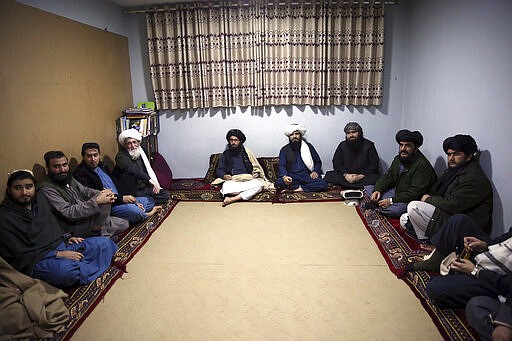 FILE- In this Dec. 14, 2019, file photo, jailed Taliban are seen after an interview with The Associated Press inside the Pul-e-Charkhi jail in Kabul, Afghanistan. After a series of delays, Afghan President Ashraf Ghani issued a decree early Wednesday, March 11, 2020,  promising to release 1,500 Taliban prisoners as a goodwill gesture to get intra-Afghan negotiations started, even though a deal signed by the United States and the Taliban calls for the release of up to 5,000 prisoners ahead of the much sought after negotiations.(AP Photo/Rahmat Gul, file)