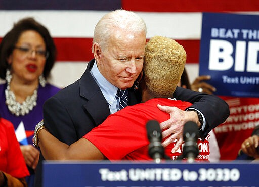 Democratic presidential candidate former Vice President Joe Biden hugs Crystal Turner of Columbus, Ohio, with Moms Demand Action during a campaign rally in Columbus, Ohio, Tuesday, March 10, 2020. (AP Photo/Paul Vernon)