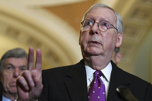 Senate Majority Leader Mitch McConnell of Ky., talks with reporters on Capitol Hill in Washington, Tuesday, March 10, 2020, following a Republican luncheon. Sen. Roy Blunt, R-Mo., listens at left. (AP Photo/Susan Walsh)