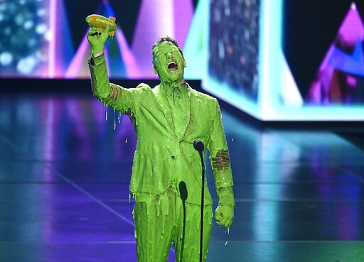 FILE - This March 23, 2019 file photo shows Chris Pratt after getting slimed as he accepts the award for favorite butt-kicker for &quot;Jurassic World: Fallen Kingdom&quot; at the Nickelodeon Kids' Choice Awards in Los Angeles. The dawning awareness of the coronavirus' reach has forced the cancellation or postponement of all major imminent events on the calendar, including the South by Southwest conference and festival in Austin, Texas; Hollywood's annual movie expo CinemaCon, in Las Vegas; this month's Kids Choice Awards in Los Angeles; and the Coachella Valley Music and Arts Festival in Indio, Calif., which was put off until October. For most people, the new coronavirus causes only mild or moderate symptoms. For some it can cause more severe illness. (Photo by Chris Pizzello/Invision/AP, File)