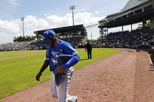 Toronto Blue Jays third baseman Vladimir Guerrero Jr. walks off the field during a spring training baseball game against the Pittsburgh Pirates, Thursday, March 12, 2020, in Bradenton, Fla. (AP Photo/Carlos Osorio)