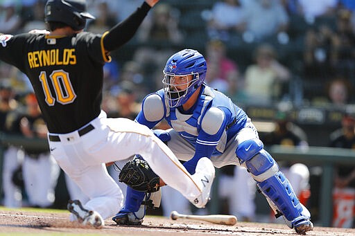 Toronto Blue Jays catcher Reese McGuire waits on the throw as Pittsburgh Pirates' Bryan Reynolds begins his slide during a spring training baseball game, Thursday, March 12, 2020, in Bradenton, Fla. (AP Photo/Carlos Osorio)