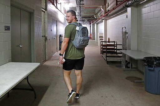 Minnesota Twins catcher Ryan Jeffers leaves Hammond Stadium after a baseball game was canceled between the Twins and the Baltimore Orioles, Thursday, March 12, 2020, in Fort Myers, Fla. Major League Baseball has suspended the rest of its spring training game schedule because if the coronavirus outbreak. MLB is also delaying the start of its regular season by at least two weeks. (AP Photo/Elise Amendola)