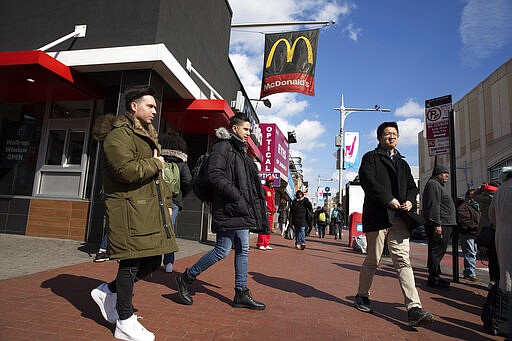 In this Feb. 28, 2020 photo, Venezuelan Kamal Morales, center, walks through his New York neighborhood. Morales' Venezuelan boyfriend, Gustavo Acosta, has spent the past year moving around U.S. immigrant detention centers in the deep south after they crossed the Mexico-U.S. border together to apply for asylum. Morales&#146; own asylum request was rejected and he was ordered deported, but is currently living in New York while on parole.&#160;(AP Photo/Mark Lennihan)