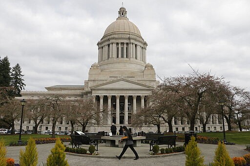 The Washington Capitol building is seen on the last day of the 60-day legislative session, Thursday, March 12, 2020, in Olympia, Wash. Lawmakers were finishing up their work amid concerns of the state's coronavirus outbreak. For most people, the new coronavirus causes only mild or moderate symptoms. For some it can cause more severe illness. (AP Photo/Rachel La Corte)