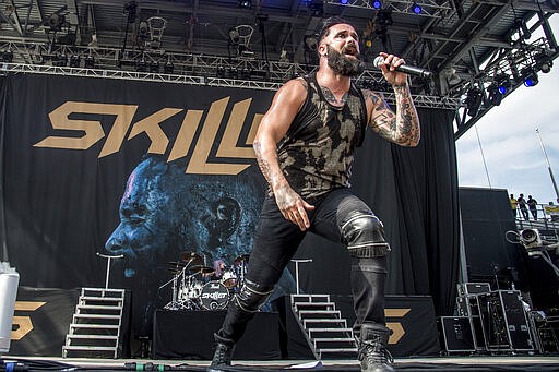 FILE - In this May 20, 2017 file photo, John Cooper of Skillet performs at Rock On The Range Music Festival in Columbus, Ohio. More and more performers are changing live concerts plans because of the new coronavirus, which has forced Mariah Carey, BTS, Pearl Jam and even the Coachella festival to postpone dates. Skillet is performing the last several dates on their current tour, with shows in New York and Virginia taking place this week. Despite the spread of the virus, Cooper said he and his bandmates are still holding meet-and-greets with concertgoers. (Photo by Amy Harris/Invision/AP, File)