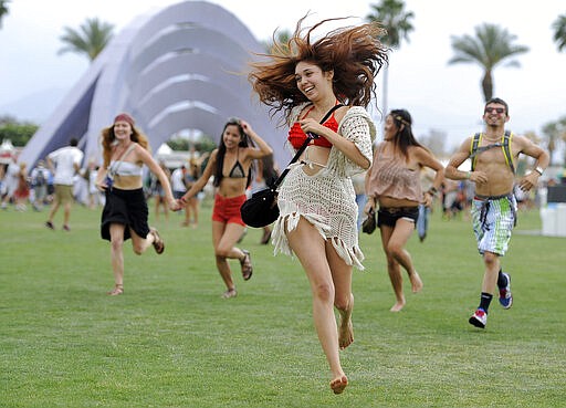 FILE - This April 13, 2012 file photo shows festivalgoers running toward the main stage at the 2012 Coachella Valley Music and Arts Festival in Indio, Calif. The Coachella music festival in Southern California has been postponed amid virus concerns.
The festival is organized by concert promoter Goldenvoice, which released a statement Tuesday saying it will be rescheduled for two weekends in October. For most people, the new coronavirus causes only mild or moderate symptoms, such as fever and cough. For some, especially older adults and people with existing health problems, it can cause more severe illness, including pneumonia. The vast majority of people recover from the new virus. According to the World Health Organization, people with mild illness recover in about two weeks, while those with more severe illness may take three to six weeks to recover. (AP Photo/Chris Pizzello, File)