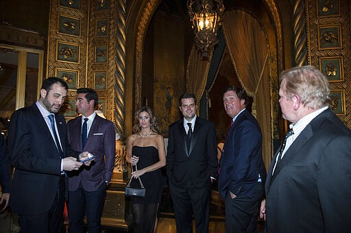 In this Saturday, March 7, 2020, photo, Rep. Matt Gaetz, R-Fla., fourth from right, and others stand before a dinner with President Donald Trump and Brazilian President Jair Bolsonaro at Mar-a-Lago in Palm Beach, Fla. (AP Photo/Alex Brandon)