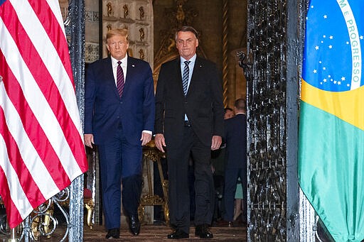 President Donald Trump arrive before a dinner with Brazilian President Jair Bolsonaro at Mar-a-Lago, Saturday, March 7, 2020, in Palm Beach, Fla. (AP Photo/Alex Brandon)