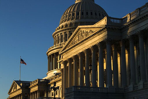 FILE - In this Dec. 18, 2019, file photo the U.S. Capitol building is illuminated by the rising sun on Capitol Hill in Washington. Congress is shutting the Capitol and all House and Senate office buildings to the public until April in reaction to the spread of the coronavirus. (AP Photo/Matt Rourke, FIle)