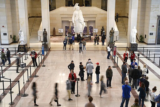 Tourists visit the Capitol Visitors Center on Capitol Hill in Washington, Thursday, March 12, 2020. Congress is shutting the Capitol to the public until April in reaction to the spread of the coronavirus, officials announced Thursday, a rare step that underscores the growing gravity with which the government is reacting to the viral outbreak. (AP Photo/Susan Walsh)