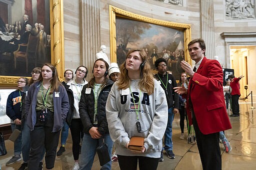 Bridget Cianfaglione, center, and fellow students from Saint John Paul II Catholic High School in Huntsville, Ala., visit the Capitol Rotunda in Washington, Wednesday, March 11, 2020. (AP Photo/J. Scott Applewhite)