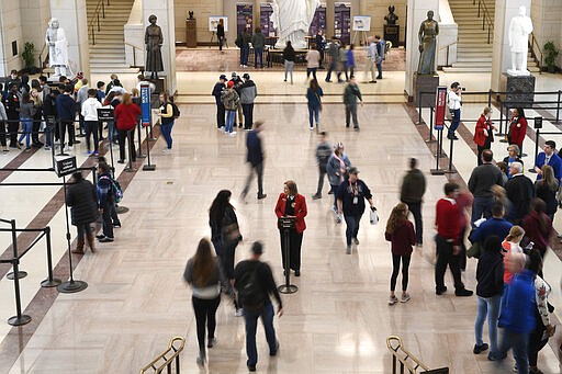 Tourists visit the Capitol Visitors Center on Capitol Hill in Washington, Thursday, March 12, 2020. Congress is shutting the Capitol to the public until April in reaction to the spread of the coronavirus, officials announced Thursday, a rare step that underscores the growing gravity with which the government is reacting to the viral outbreak. (AP Photo/Susan Walsh)