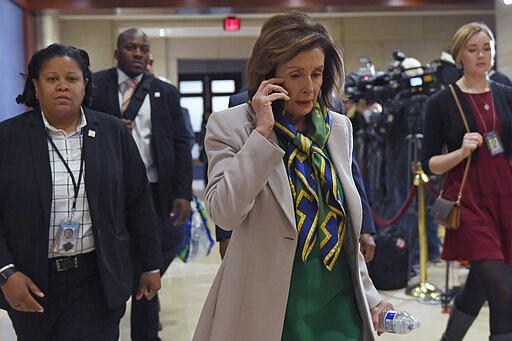 House Speaker Nancy Pelosi of Calif., walks on Capitol Hill in Washington, Thursday, March 12, 2020, as she heads to a briefing on the coronavirus. (AP Photo/Susan Walsh)