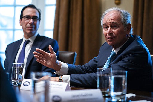 Treasury Secretary Steven Mnuchin, left, listens as Blackstone CEO Stephen Schwatrzman speaks during a meeting with President Donald Trump and banking industry executives on the coronavirus, at the White House, Wednesday, March 11, 2020, in Washington. (AP Photo/Evan Vucci)