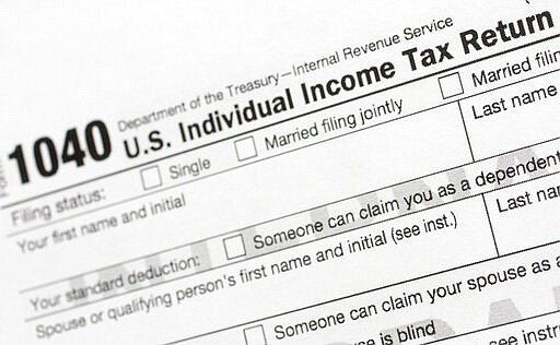 FILE - This July 24, 2018, file photo shows a portion of the 1040 U.S. Individual Income Tax Return form. The Trump administration is working on plans to delay the April 15 federal tax deadline for most individual taxpayers as well as small businesses. Treasury Secretary Steven Mnuchin told Congress on Wednesday, March 11, 2020, that the administration is &#147;looking at providing relief to certain taxpayers and small businesses who will be able to get extensions on their taxes.&#148; (AP Photo/Mark Lennihan, File)