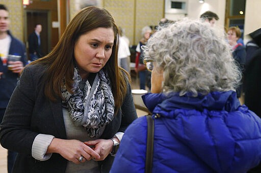 In this photo from Feb. 18, 2020, Nikki Foster, democratic candidate for Ohio's first congressional district, greets a woman following a question and answer session held by the Bold New Democracy Work Group, in Cincinnati. Some years, Democrats have struggled to field a viable candidate in Ohio's 1st U.S. House district. This year, they have two. Foster, a veteran Air Force pilot, and Kate Schroder, a career health-care advocate, who have shown the ability to raise money and attract supporters as they prepare to clash in the state's March 17 primary for the nomination to challenge 12-term Republican incumbent Steve Chabot of Cincinnati. (AP Photo/Gary Landers)