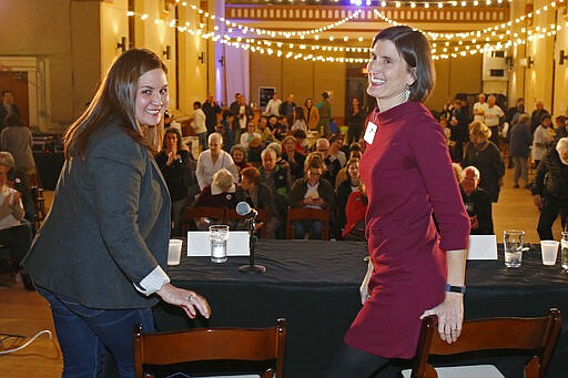 In this photo from Feb. 18, 2020, Nikki Foster, left, and Kate Schroder, democratic candidates for Ohio's first congressional district, are photographed following a question and answer session held by the Bold New Democracy Work Group, in Cincinnati. Some years, Democrats have struggled to field a viable candidate in Ohio's 1st U.S. House district. This year, they have two. A career health-care advocate, Schroder, and a veteran Air Force pilot, Foster, have shown the ability to raise money and attract supporters as they prepare to clash in the state's March 17 primary for the nomination to challenge 12-term Republican incumbent Steve Chabot of Cincinnati. (AP Photo/Gary Landers)