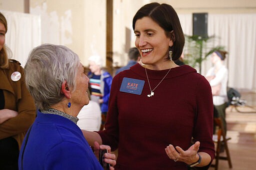 In this photo from Feb. 18, 2020, Kate Schroder, democratic candidate for Ohio's first congressional district, right, greets a woman following a question and answer session held by the Bold New Democracy Work Group, in Cincinnati. Some years, Democrats have struggled to field a viable candidate in Ohio's 1st U.S. House district. This year, they have two. Schroder, a career health-care advocate, and Nikki Foster, a veteran Air Force pilot, who have shown the ability to raise money and attract supporters as they prepare to clash in the state's March 17 primary for the nomination to challenge 12-term Republican incumbent Steve Chabot of Cincinnati. (AP Photo/Gary Landers)