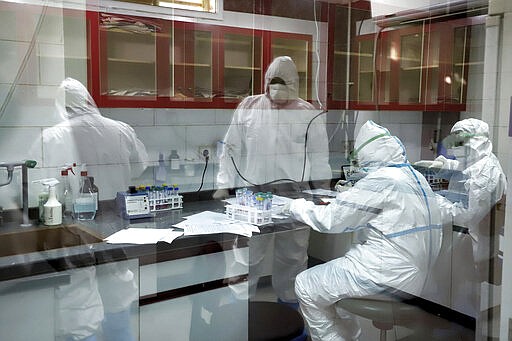 In this Tuesday, March, 10, 2020 photo, paramedics test samples taken from patients suspected of being infected with the new coronavirus, at a laboratory in the southwestern city of Ahvaz, Iran. For most people, the new coronavirus causes only mild or moderate symptoms, such as fever and cough. For some, especially older adults and people with existing health problems, it can cause more severe illness, including pneumonia. (Amin Nazari/ISNA via AP)