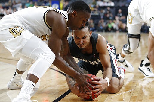 Colorado's McKinley Wright IV, left, and Washington State's Isaac Bonton scramble for the ball during the first half of an NCAA college basketball game in the first round of the Pac-12 men's tournament Wednesday, March 11, 2020, in Las Vegas. (AP Photo/John Locher)