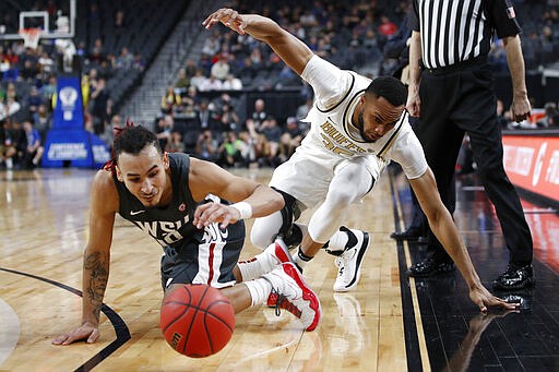 Washington State's Isaac Bonton, left, and Colorado's Dallas Walton scramble for the ball during the first half of an NCAA college basketball game in the first round of the Pac-12 men's tournament Wednesday, March 11, 2020, in Las Vegas. (AP Photo/John Locher)