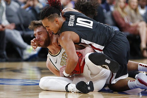 Colorado's Lucas Siewert, left, and Washington State's Isaac Bonton scramble for the ball during the first half of an NCAA college basketball game in the first round of the Pac-12 men's tournament Wednesday, March 11, 2020, in Las Vegas. (AP Photo/John Locher)