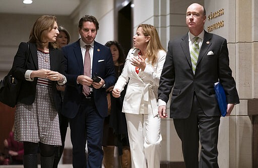 From left, Rep. Kim Schrier, D-Va., Rep. Dean Phillips, D-Minn., Rep. Debbie Mucarsel-Powell, D-Fla., and Rep. Robert Aderholt, D-Ala., leave a briefing by government health officials for members of Congress on the coronavirus outbreak, in Washington, Thursday, March 12, 2020. (AP Photo/J. Scott Applewhite)