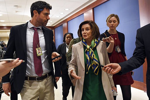 House Speaker Nancy Pelosi of Calif., is followed by reporters as she walks on Capitol Hill in Washington, Thursday, March 12, 2020. (AP Photo/Susan Walsh)