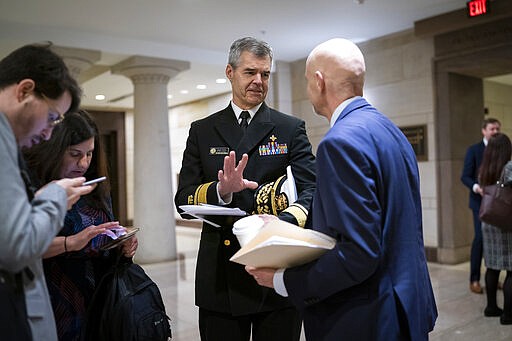 Rear Adm. Stephen Redd of the U.S. Public Health Service, center, confers with Dr. Stephen Hahn, commissioner of the Food and Drug Administration, as they and other officials prepare to update all members of Congress on the coronavirus outbreak, in Washington, Thursday, March 12, 2020. (AP Photo/J. Scott Applewhite)