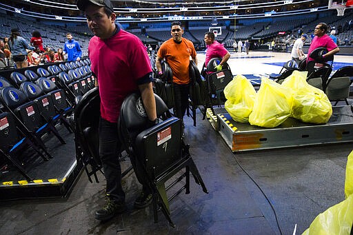 Crews remove chairs from the court after the Dallas Mavericks defeated the Denver Nuggets in an NBA basketball game on Wednesday, March 11, 2020 at American Airlines Center in Dallas. The NBA has suspended its season &#147;until further notice&quot; after a Utah Jazz player tested positive Wednesday for the coronavirus, a move that came only hours after the majority of the league's owners were leaning toward playing games without fans in arenas. The vast majority of people recover from the new coronavirus. According to the World Health Organization, most people recover in about two to six weeks, depending on the severity of the illness.  (Ashley Landis /The Dallas Morning News via AP)