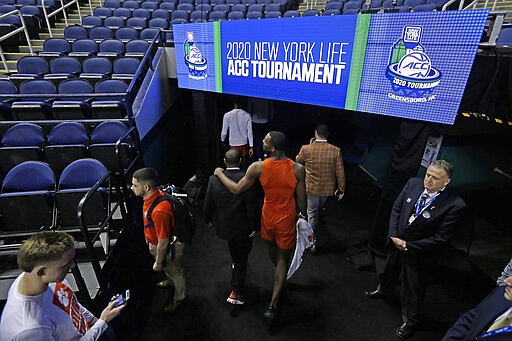 Clemson players leave the floor after the NCAA college basketball games at the Atlantic Coast Conference tournament were canceled due to concerns over the coronavirus in Greensboro, N.C., Thursday, March 12, 2020. (AP Photo/Gerry Broome)