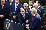 Despite coronavirus, Trump keeps shaking hands