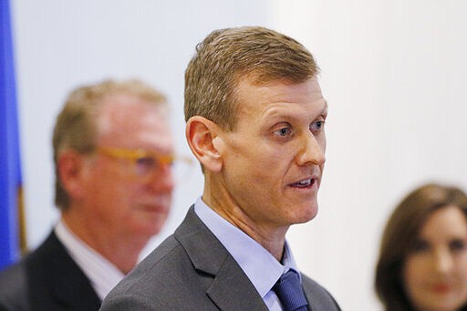 State epidemiolgist Laurence Burnsed speaks as Health Commissioner Gary Cox and Joy Hofmeister, state superintendent of Public Instruction Guidance, in background, look on Thursday, March 12, 2020. Oklahoma government officials had a press conference to discuss the state's response to the COVID-19. (Doug Hoke/The Oklahoman via AP)