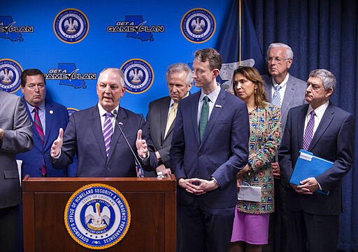 Louisiana Gov. John Bel Edwards, at podium, speaks during a news conference updating the status of the coronavirus threat in the state, Wednesday, March 11, 2020, at the Governor's Office of Homeland Security &amp; Emergency Management, in Baton Rouge, La. Some of the members of the Unified Command Group are behind him, including, from left, Lt. Gov. Billy Nungesser; Jimmy Guidry, M.D., State Health Officer of Louisiana and Louisiana Department of Health Medical Director; Alex Billioux, M.D., Assistant Secretary of Health for the Louisiana Department of Health's Office of Public Health; Ava Dejoie, Secretary of the Louisiana Workforce Commission; Louisiana Insurance Commissioner Jim Donelon and Commissioner of Administration Jay Dardenne. (Travis Spradling/The Advocate via AP)