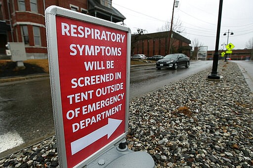 A sign directs patients with respiratory symptoms to a tent at the Central Maine Medical Center, Friday, March 13, 2020, in Lewiston, Maine. The hospital is using the tent to make preliminary test for patients with coronavirus symptoms. (AP Photo/Robert F. Bukaty)