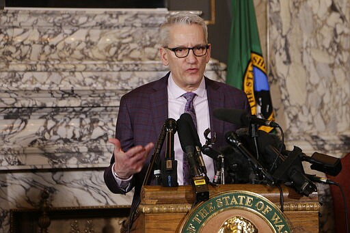State Secretary of Health John Wiesman talks to the media about the decision to close schools in three counties in response to COVID-19, Thursday, March 12, 2020, in Olympia, Wash. All public and private K-12 schools in King, Pierce and Snohomish counties will be closed for six weeks, and Gov. Jay Inslee said there could be closures in more counties soon. (AP Photo/Rachel La Corte)