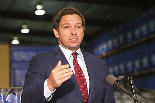 Florida Gov. Ron DeSantis answers questions at a news conference at an emergency management warehouse about the spread of the coronavirus, Friday March 13, 2020 in Tallahassee, Fla. The vast majority of people recover from the new coronavirus. According to the World Health Organization, most people recover in about two to six weeks, depending on the severity of the illness. (AP Photo/Steve Cannon)