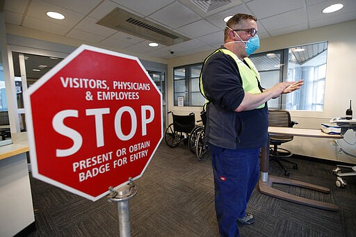 Bradley Mattes, associate nurse leader at Central Maine Medical Center, questions patients at the emergency entrance to the hospital, Friday, March 13, 2020, in Lewiston, Maine. &quot;I refer to myself as the Walmart greeter of nurses,&quot; said Mattes, who questions patients to determine if their symptoms indicate the need for testing for the coronavirus or other medical attention. (AP Photo/Robert F. Bukaty)