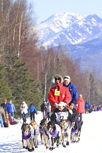 FILE - In this March 1, 2014 file photo, musher Jessie Royer of Darby, Mont., drivers her dog team along Campbell Air Strip near the end of the ceremonial start of the 2014 Iditarod Trail Sled Dog Race in Anchorage, Alaska. One Iditarod musher ditched the frozen foods heated over a campfire for a gourmet meal Friday morning, March 13, 2020. Royer of Fairbanks was the first musher to reach the checkpoint in Ruby, Alaska, and a huge spread prepared by a chef flown in from Anchorage awaited her when she pulled into town with 14 dogs in harness at 6:37 a.m. (AP Photo/Dan Joling, File)