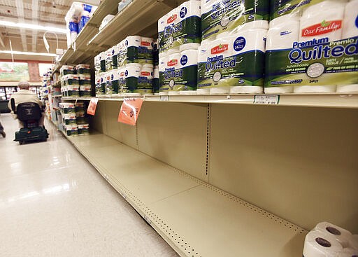 Shelves are empty at Roger's Foodland, Friday, March 13, 2020, in St. Joseph, Mich. Michigan Gov. Gretchen Whitmer on Friday ordered the cancellation or postponement of all events and gatherings of more than 250 people in an attempt to combat the spread of the coronavirus, exempting industrial work, mass transit and the purchase of groceries or consumer goods..(Don Campbell/The Herald-Palladium via AP)