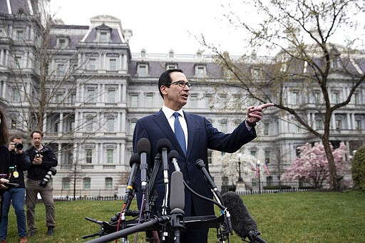 Treasury Secretary Steve Mnuchin speaks with reporters about the effects from the coronavirus, at the White House, Friday, March 13, 2020, in Washington. (AP Photo/Alex Brandon)