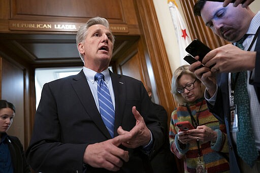 House Minority Leader Kevin McCarthy, R-Calif., assures reporters that a bipartisan coronavirus aid package deal between House Speaker Nancy Pelosi and the Trump administration will get a vote, on Capitol Hill in Washington, Friday, March 13, 2020. (AP Photo/J. Scott Applewhite)