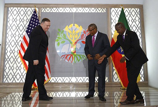 FILE - In this Tuesday Feb. 18, 2020 file photo, US Secretary of State Mike Pompeo, left, meets with Ethiopian Minister of Foreign Affairs Gedu Andargachew, center, at the Foreign Ministry in Addis Ababa. In an interview with The Associated Press on Thursday March 12, 2020, Ethiopia's foreign minister said his country is refusing to be pressured by the U.S. into signing a deal with Egypt and Sudan over Ethiopia's controversial dam on the Nile River. (Andrew Caballero-Reynolds/Pool Photo via AP, File)