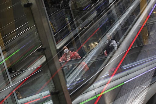 Passengers wearing masks arrive at Adolfo Suarez-Barajas international airport, outskirts Madrid, Spain, Thursday, March 12, 2020. The vast majority of people recover from the new coronavirus. According to the World Health Organization, most people recover in about two to six weeks, depending on the severity of the illness. (AP Photo/Bernat Armangue)