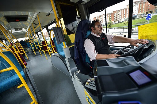 Txutxin Zudaire drives an empty public bus, in Pamplona, northern Spain, Friday, March 13, 2020. For most people, the new COVID-19 coronavirus causes only mild or moderate symptoms, such as fever and cough, but for some, especially older adults and people with existing health problems, it can cause more severe illness, including pneumonia. (AP Photo/Alvaro Barrientos)